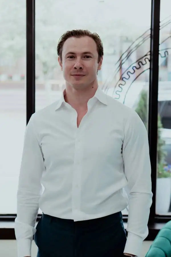 A crisp white long-sleeved button-down shirt with a classic collar and neatly pressed fabric.