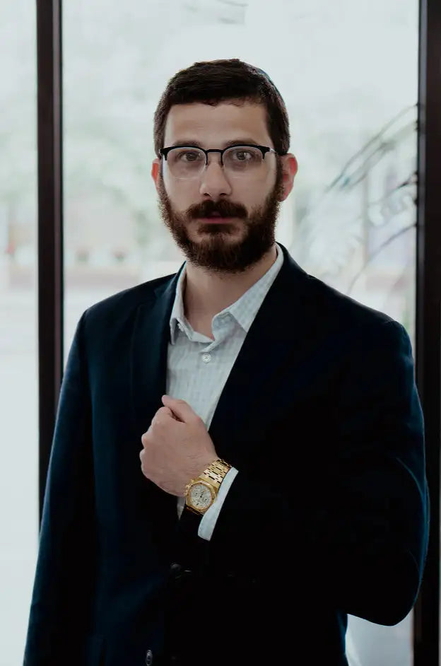 Gold-toned wristwatch with a classic round face and linked bracelet.