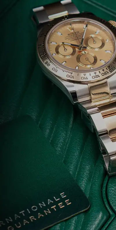 A luxurious two-tone stainless steel and gold rolex daytona watch with a champagne-colored dial, featuring three subdials and a tachymeter bezel.