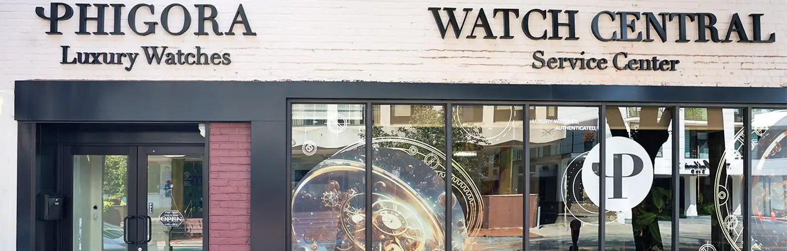Phigora luxury watches storefront with black and white signage above a glass window displaying an ornate watch face.