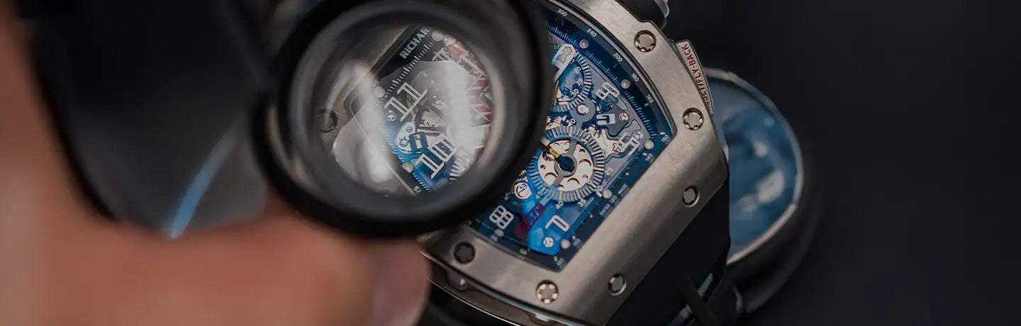 A sleek silver-toned richard mille watch with a vibrant blue dial and intricate mechanical details.