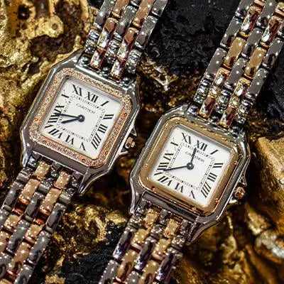 Two elegant cartier santos watches with silver and rose gold two-tone links, featuring diamond-encrusted bezels and classic roman numeral dials.